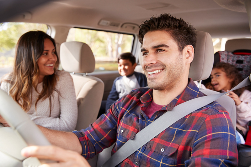 A husband driving his family to an event