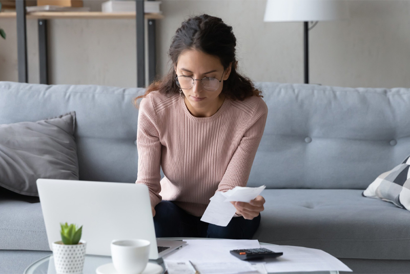 A woman typing on her laptop