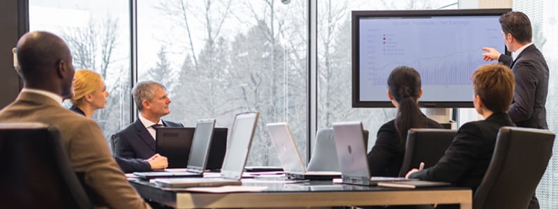 A meeting amongst teammates in a board room