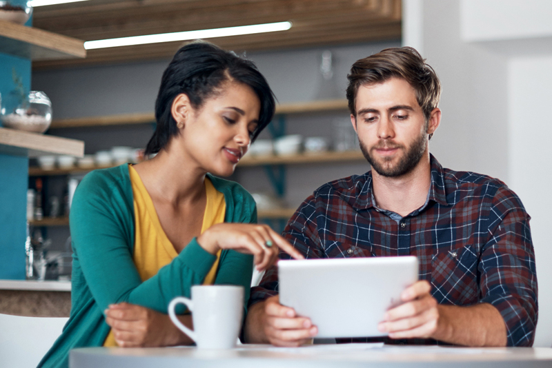 Two friends looking at their financials