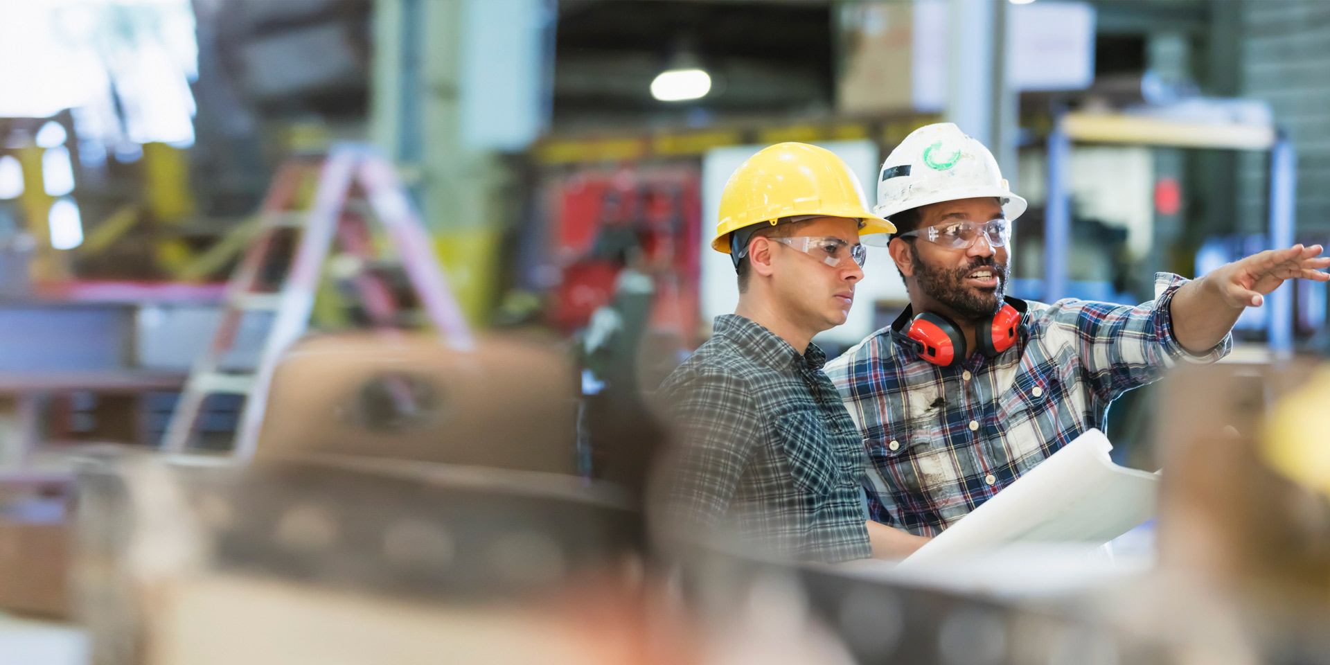 Two coworkers discussing options within the production line