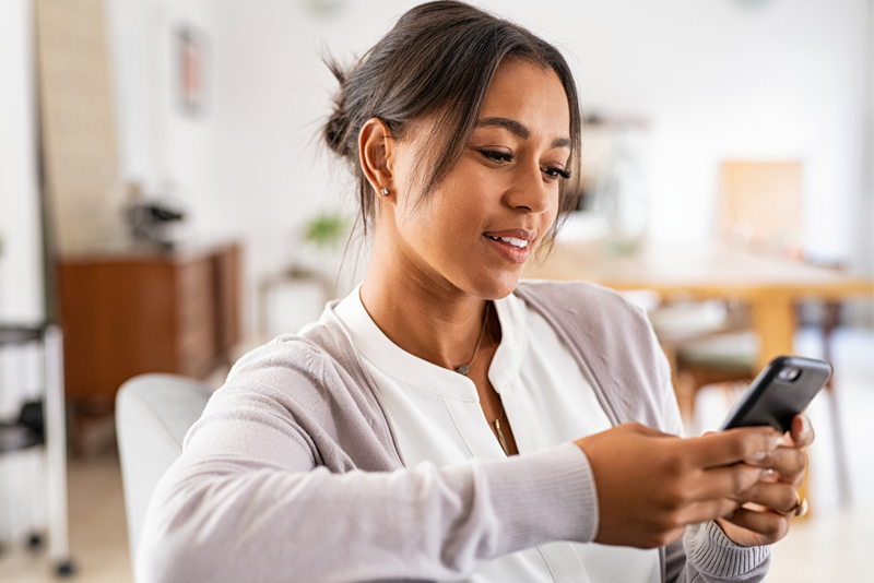 A woman making a loan payment on her mobile device