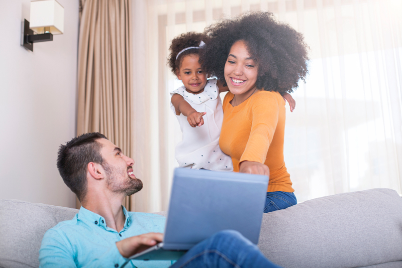 A couple looking at homes together on his laptop