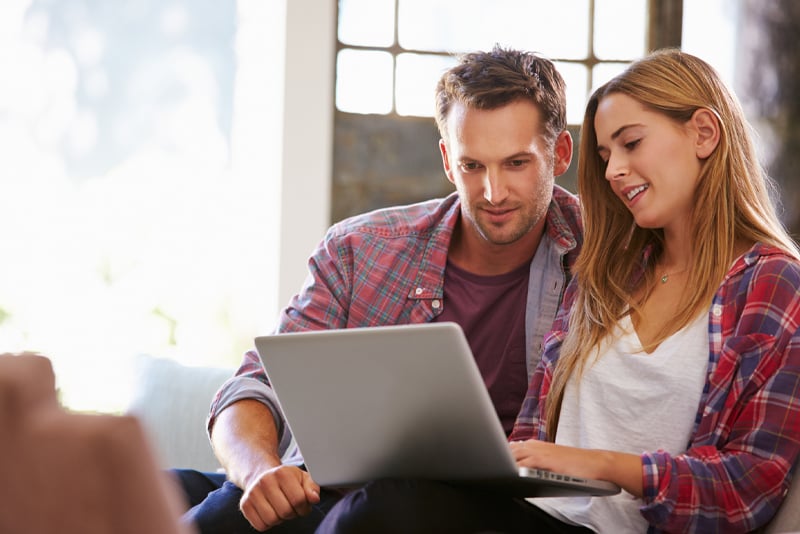 A couple looking online for a new loan