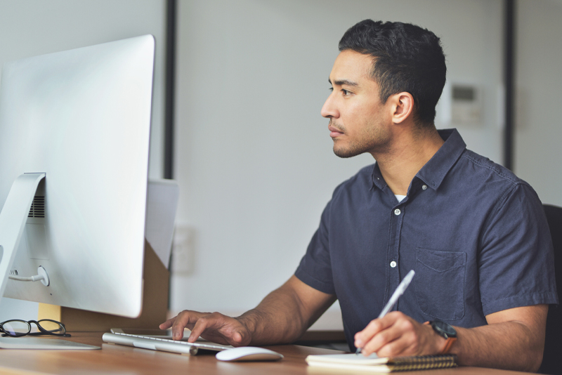 A man researching new mortgages on his computer