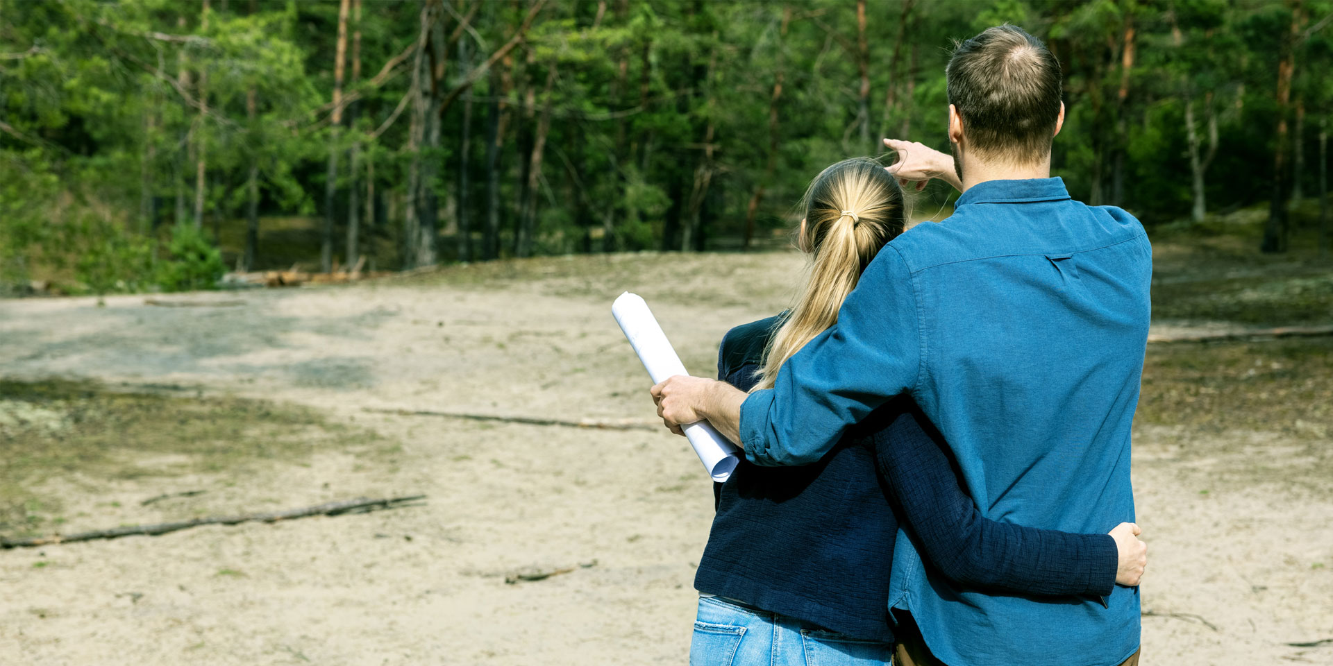 A couple taking a look at their new land purchase