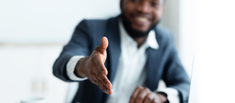 A man wanting to shake someone's hand