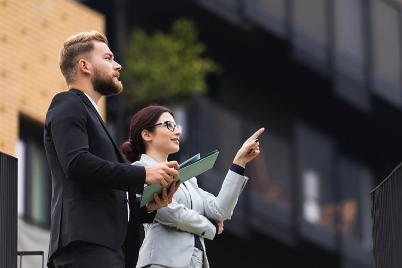 Two colleagues outside looking at a building