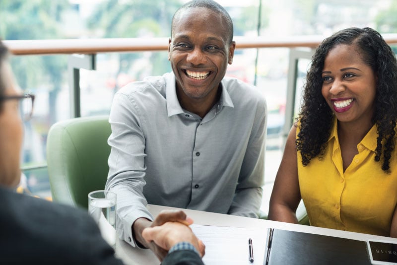 A couple meeting with a lender to talk about mortgage options