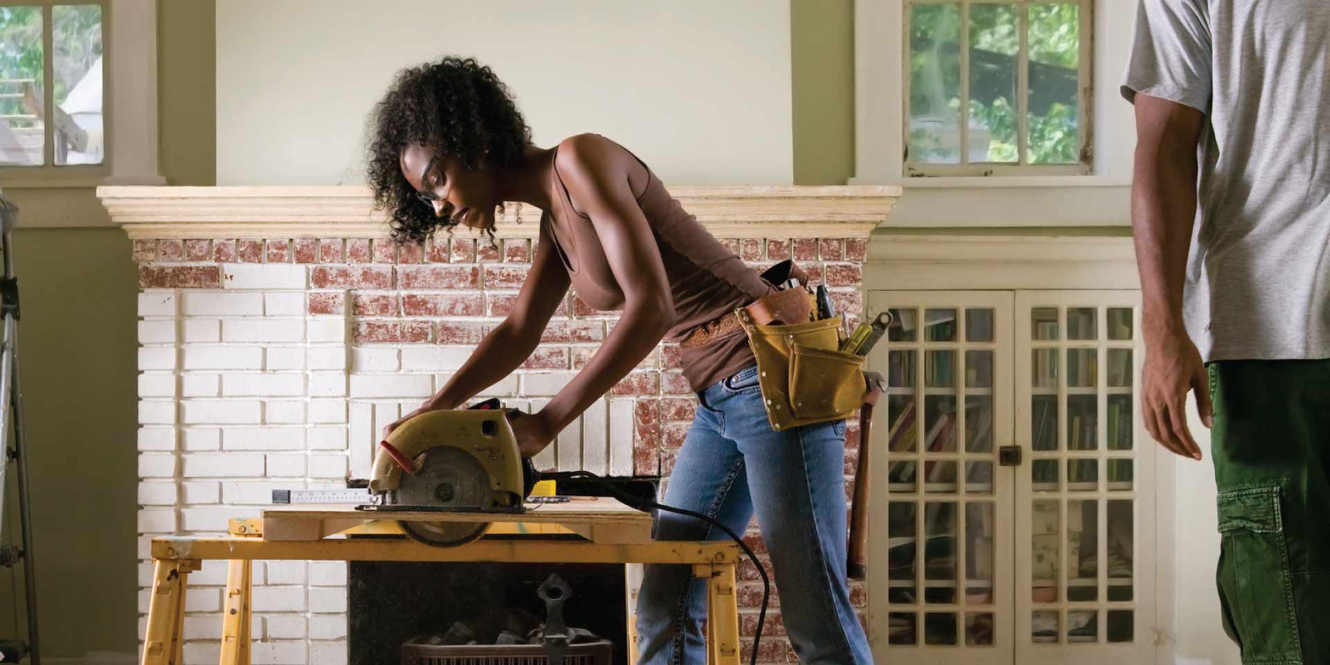 A woman working on fixing up her house