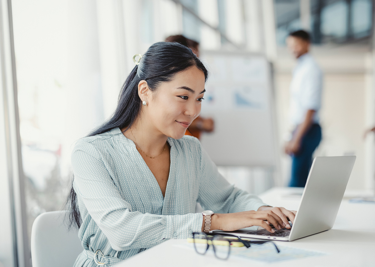 A woman typing on her computer