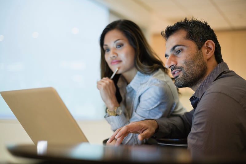 Two coworkers researching ransomware information