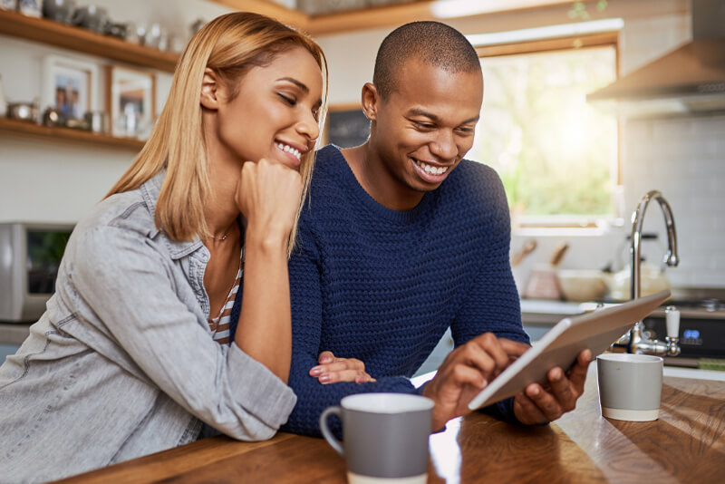 A young couple researching auto rates