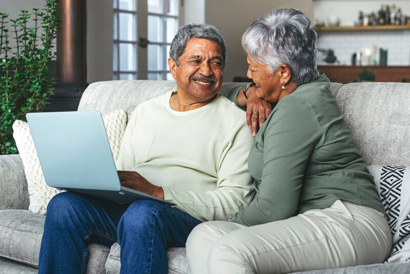 An older couple on their laptop