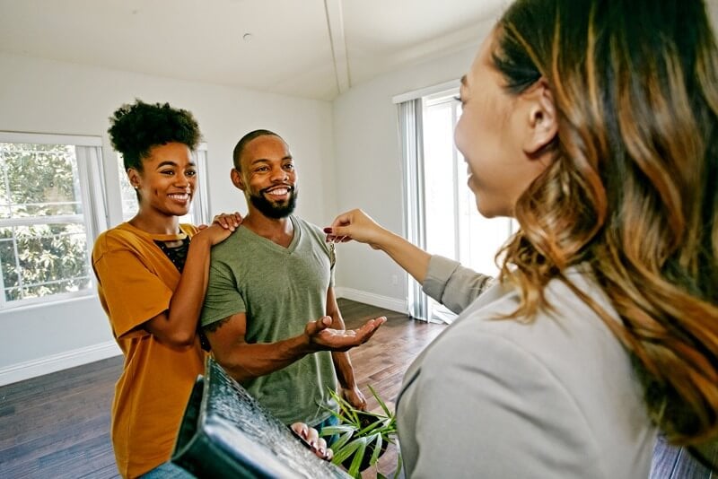 A couple getting their keys to their first home