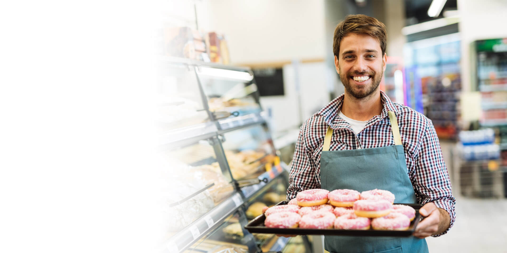 A new coffee shop owner serving homemade donuts