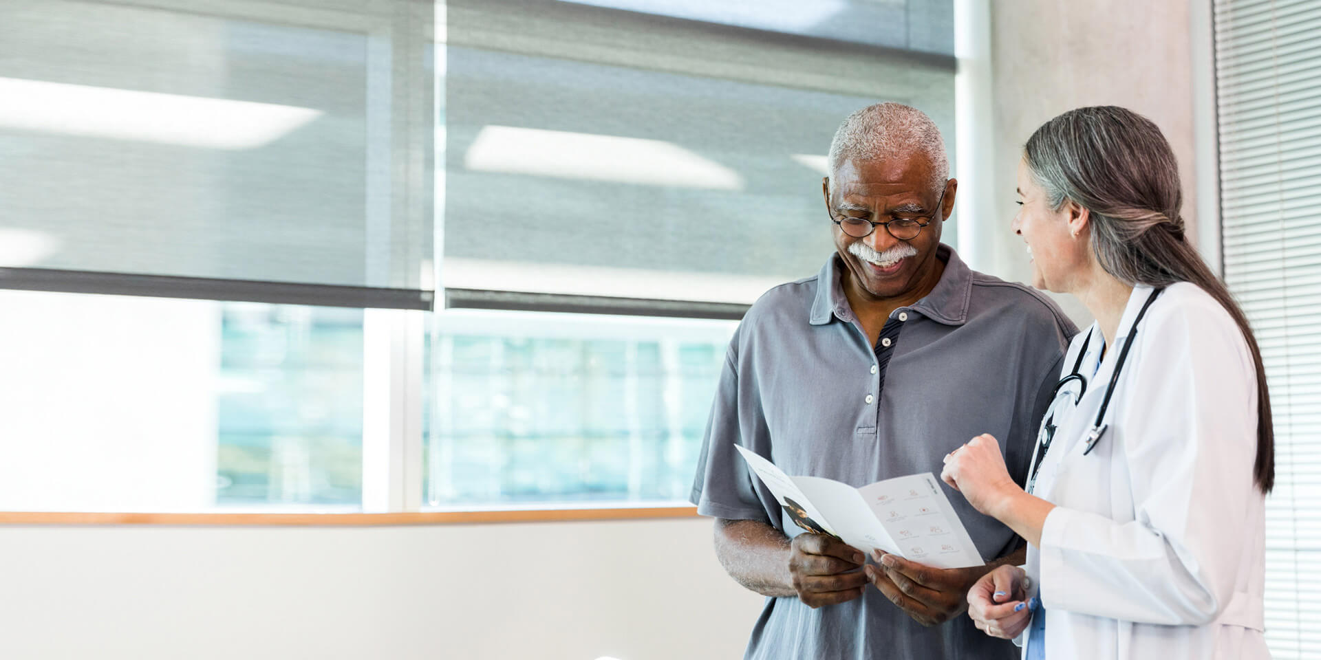 A man talking to his doctor about his records