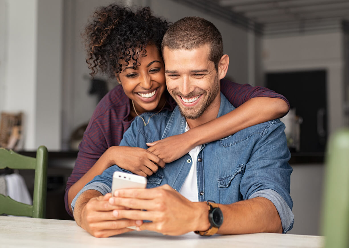 A couple looking at his phone for some wealth information at his local Old National Bank