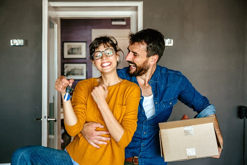 A couple moving into their first home