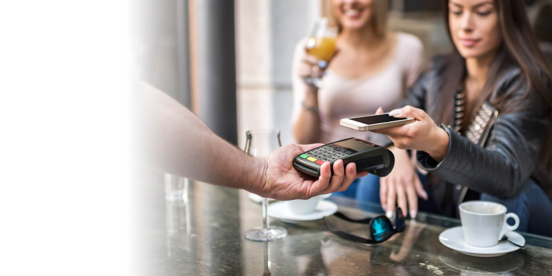 A woman paying with her mobile device