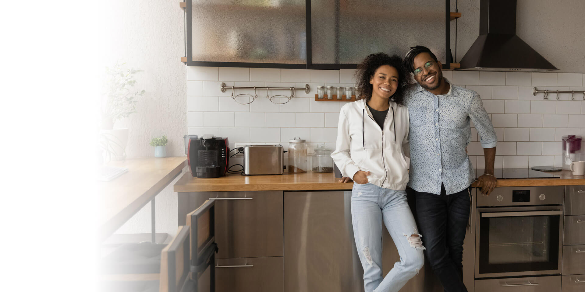 A couple standing in their kitchen