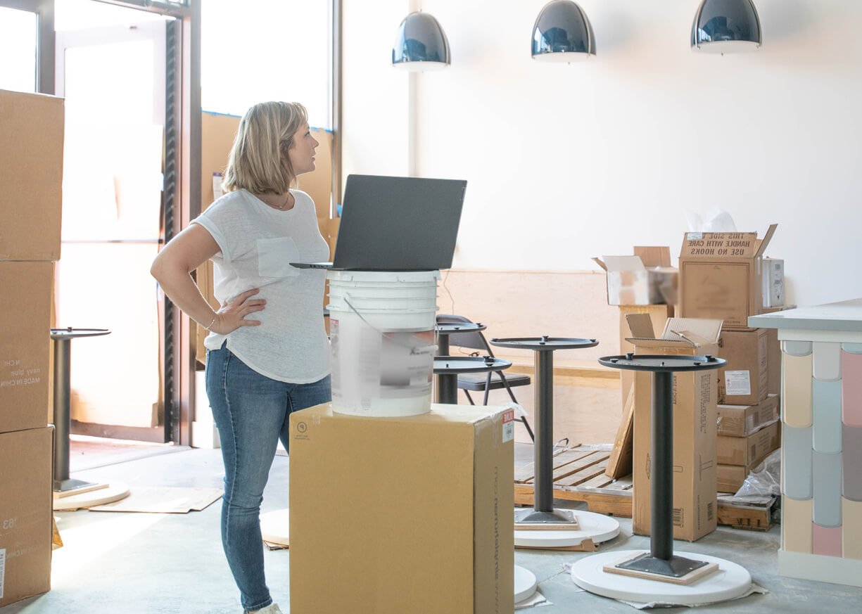 A woman opening up a store front