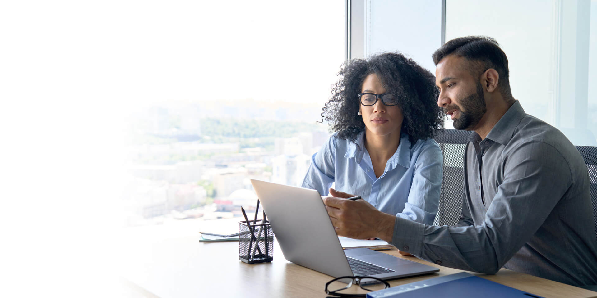 Two coworkers looking at ways to find efficiencies